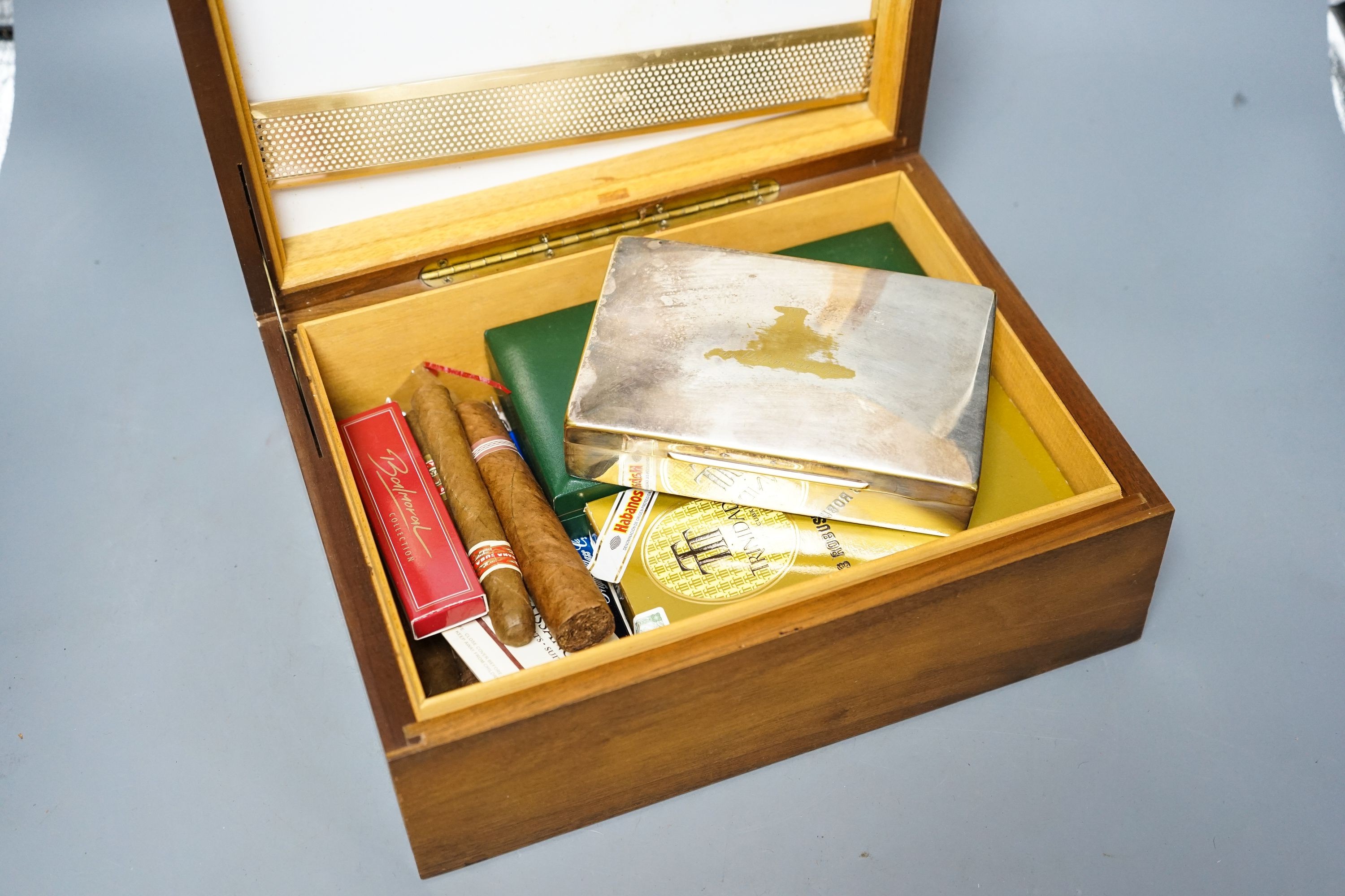 A cased Davidoff cigar cutter, walnut humidor, plated cigarette box, various cigars etc.